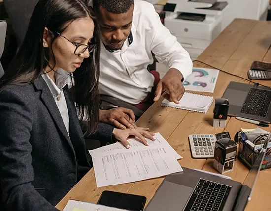 Canadian employer meeting with a recruitment consultant to discuss LMIA job advertising services in a professional office